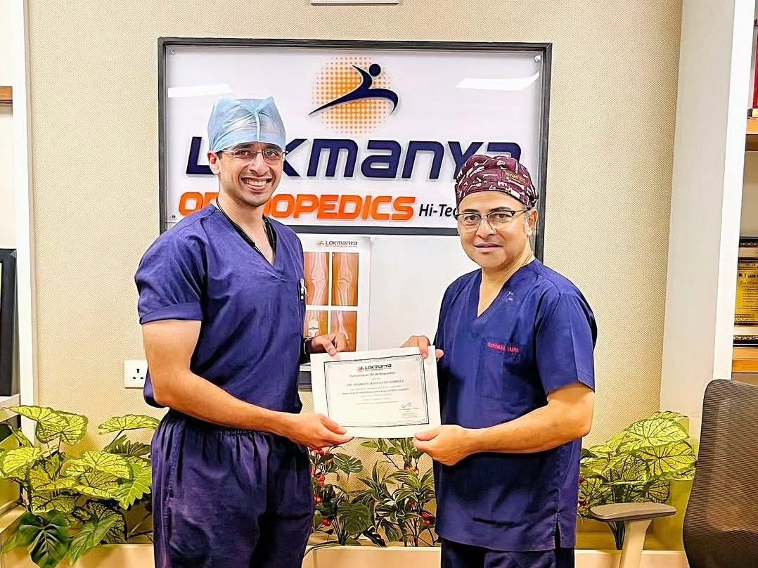 Dr. Godbole receiving his MUHS fellowship completion certificate from Dr. Narendra Vaidya